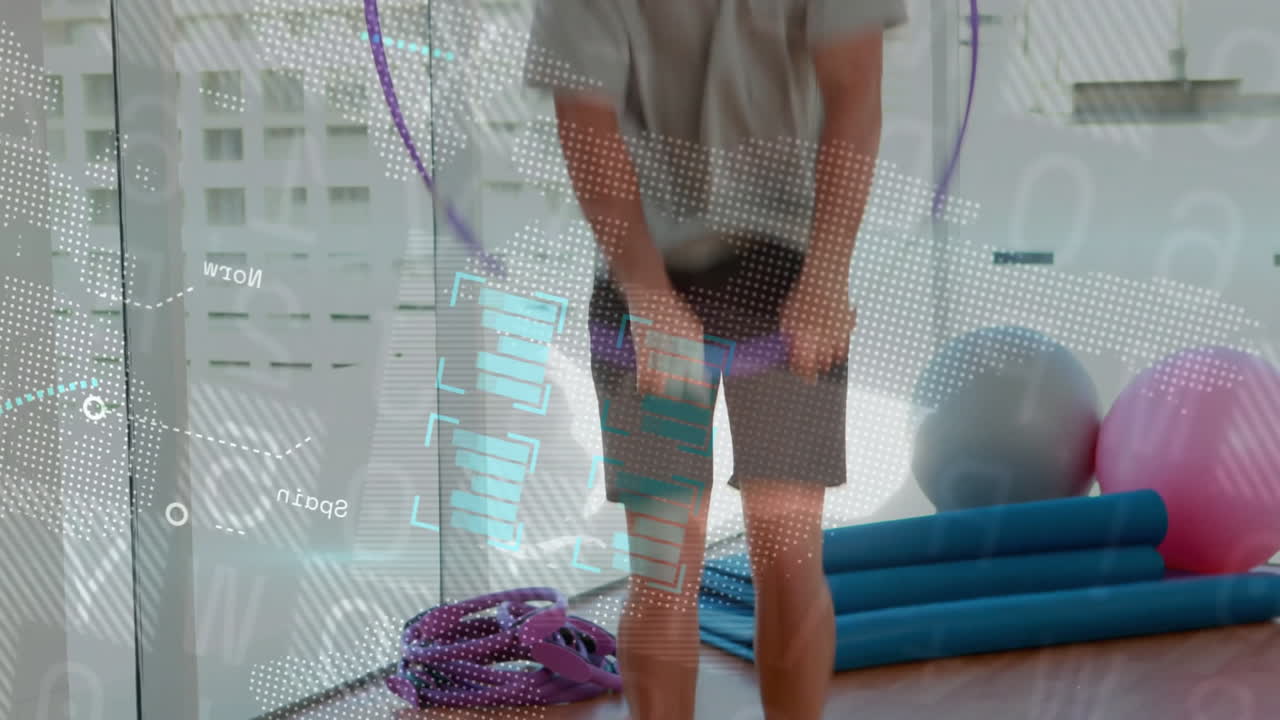 Man practicing workout in health studio, with blue mats, purple band, overlaying data charts