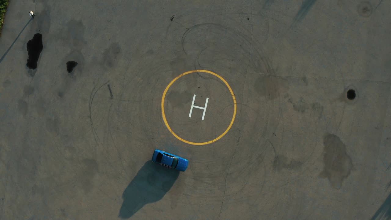 Ariel overhead shot drift sports car in a circle