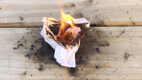 closeup-view-of-person-setting-tissue-on-fire-using-friction-on-wood