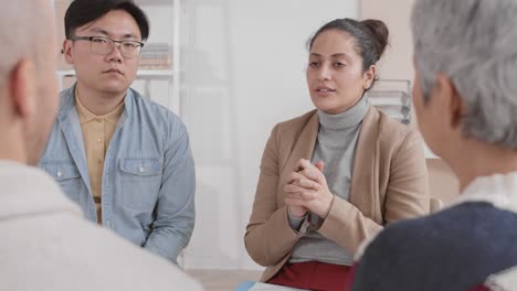 mixed race woman hosting group therapy