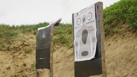 wind blow up paper target attached on wooden wall at olesko shooting range