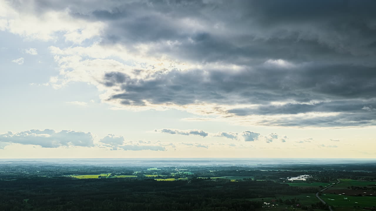 Dramatic hyperlapse of storm clouds over vast countryside landscape