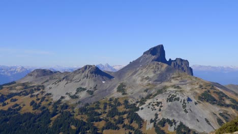 black tusk volcanic mountain under blue sky in garibaldi provincial park in canada