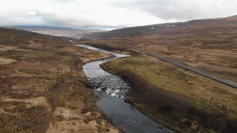 Aerial-footage-of-a-fast-moving-river-hitting-hard-on-every-rock-it-passes-by