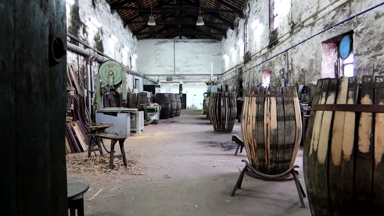 Cooper's workshop in a wine cellar restoring big vats with machinery