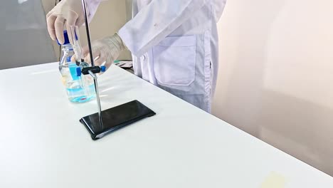 scientist conducts naoh chemical reaction in a lab setting, highlighting precise movements and controlled environment