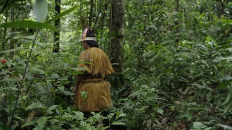 Native-people-walk-on-a-trail-in-the-dense-forest-in-Leticia,-Amazon,-Colombia