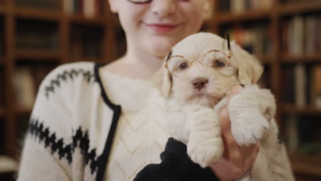 a girl with a pet in the library. portrait of a schoolgirl