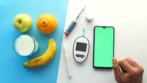 diabetic measurement tools and person hand using smart phone