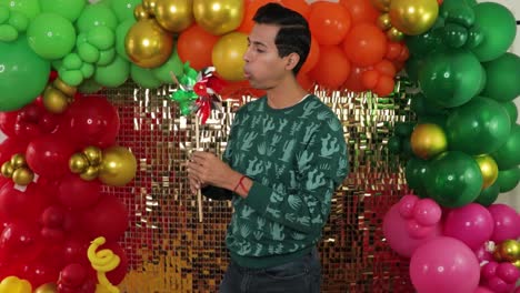 young mexican man celebrating, spinning traditional windmill with festive backdrop