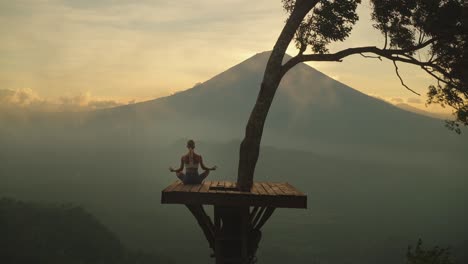 popular lahangan sweet view platform at mount agung with woman in lotus pose