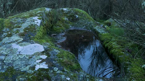 Water-shimmers-and-blows-in-wind-in-pool-of-Anthropomorphic-burial-tombs