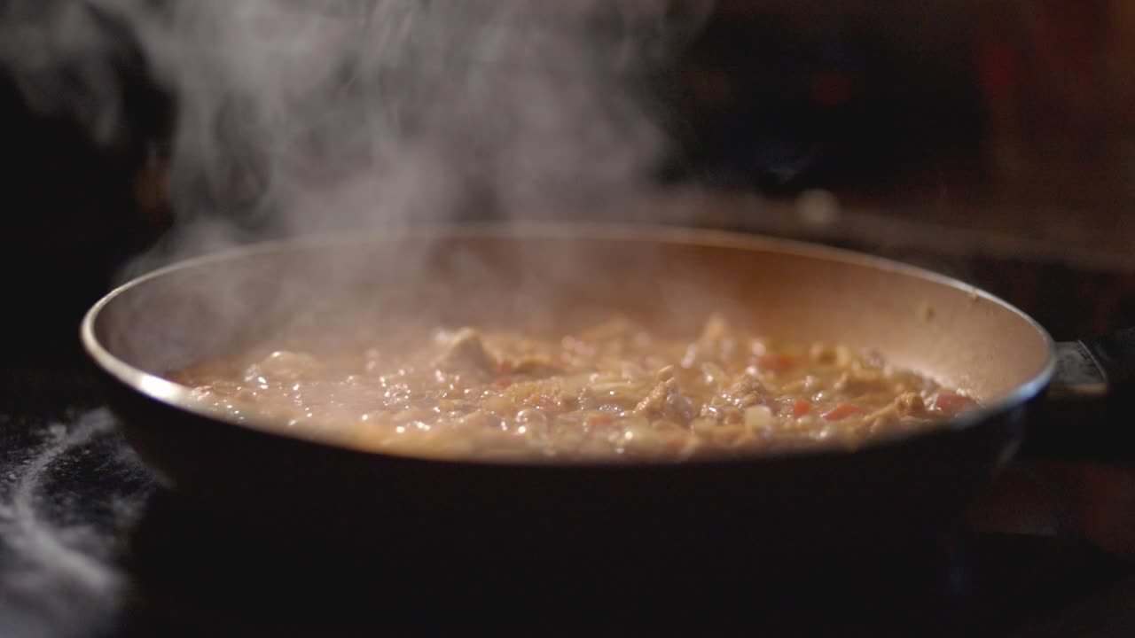 Cooking Delicious Saucy Meal In A Pan In The Kitchen - close up