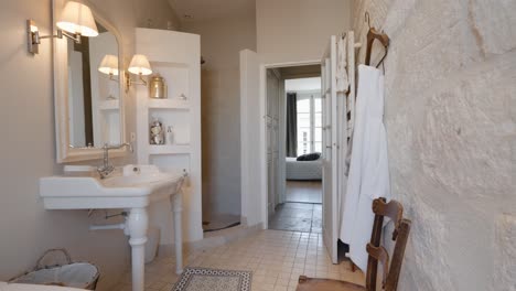 slow establishing shot of an open stone shower with an standalone bathtub