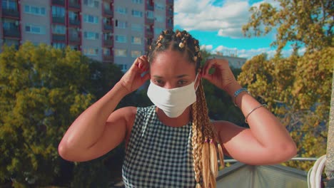 young beautiful mixed race woman putting a face mask on her head, slow motion