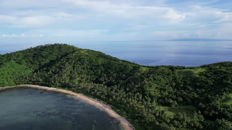A-breathtaking-aerial-panning-shot-of-Catanduanes-Island-surrounded-by-the-ocean,-showcasing-its-stunning-bays-and-beaches