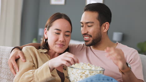 Popcorn,-eating-and-love-with-a-couple-laughing