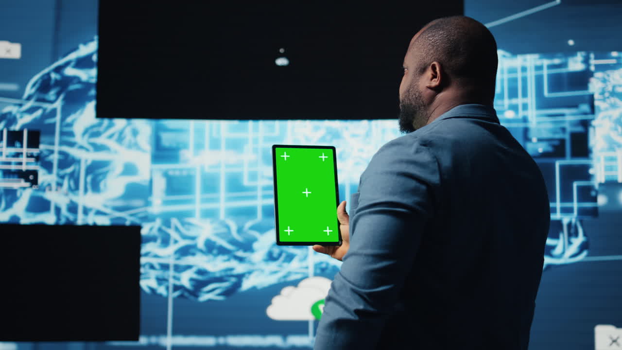 African american expert holds tablet with isolated screen next to systems