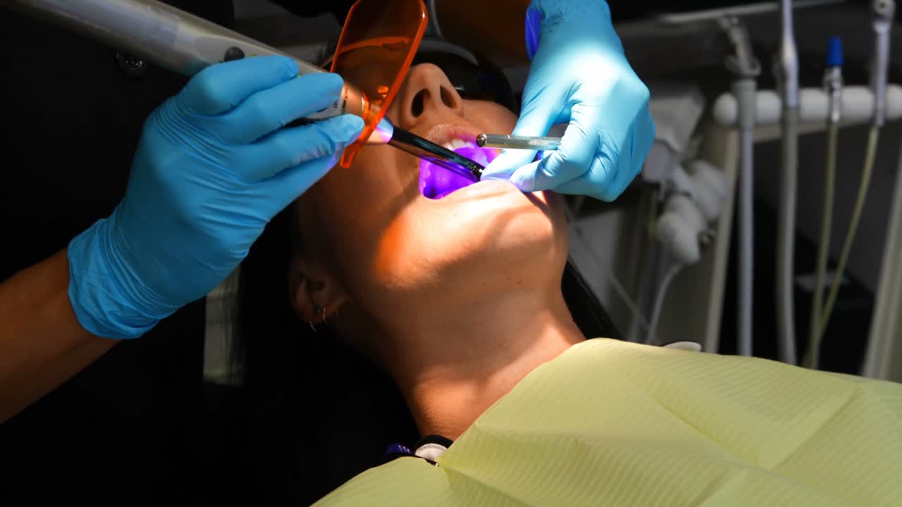 Dentist examining a patient with tools 4k