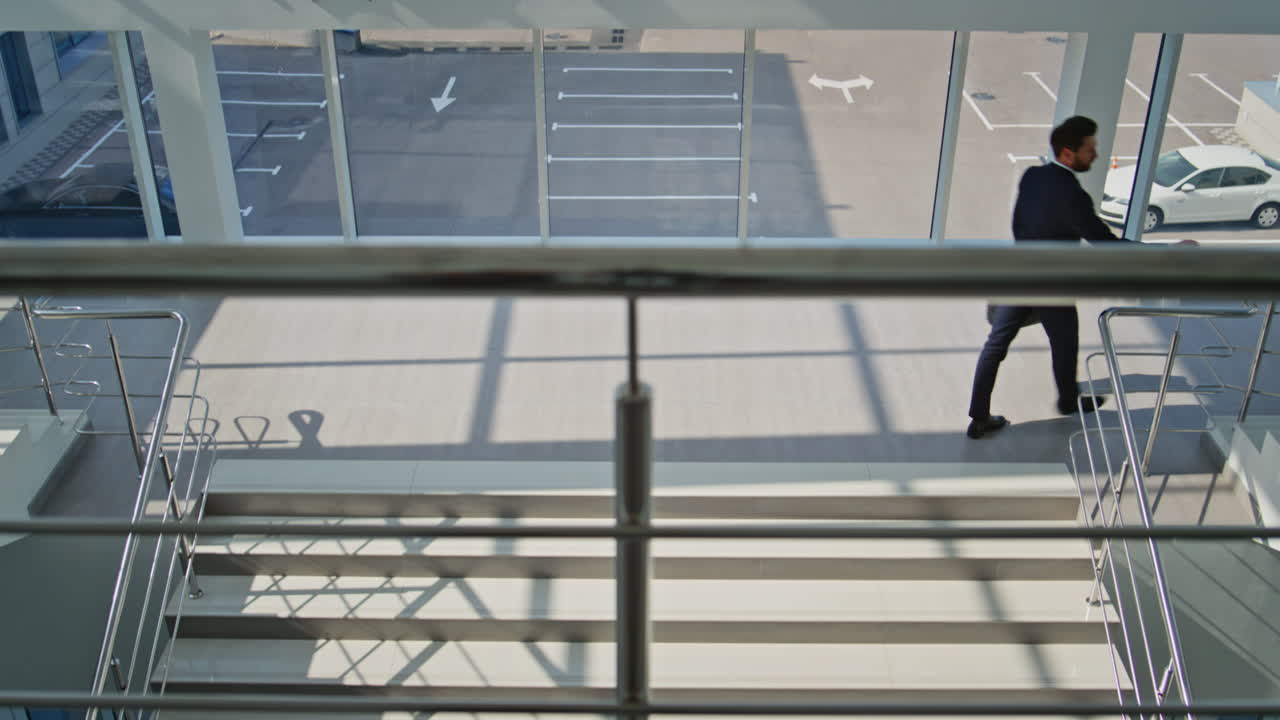 Confident professional ascending stairs in office building. Elegant businessman