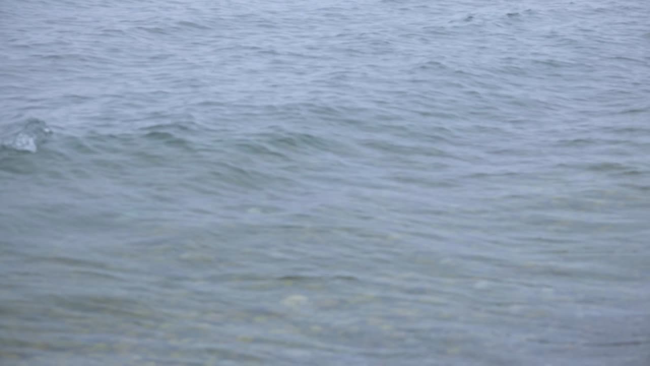 Sea Waves Rolling Upon The Shore On A Sunny Day - Medium Shot