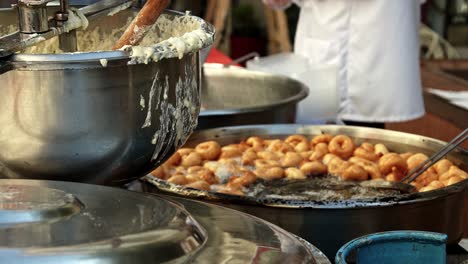 street vendor cooks and sells hot oil dough