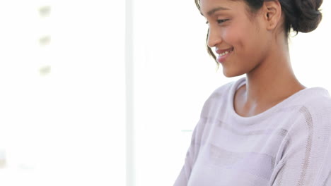 Smiling-businesswoman-typing-on-her-laptop