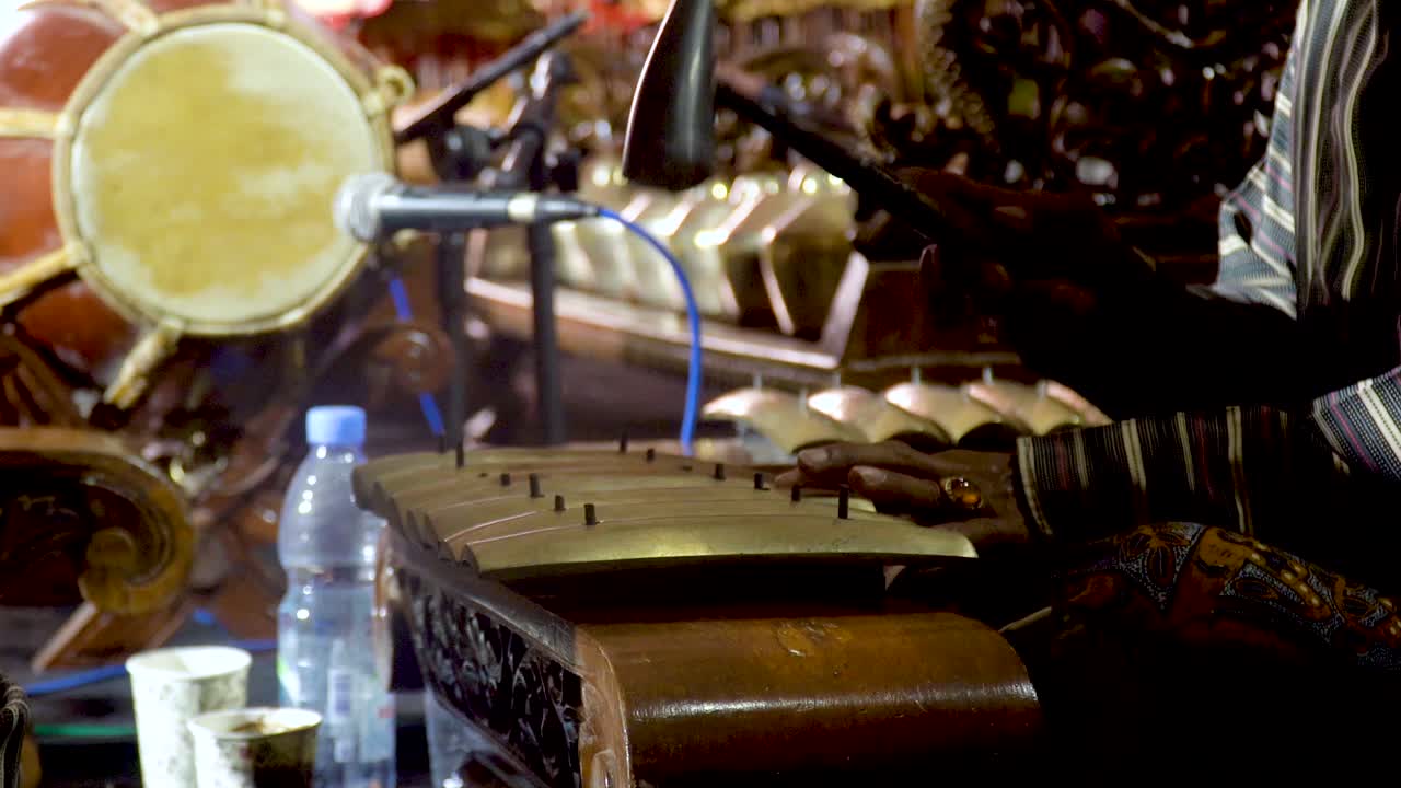 Gamelan Javanese music performance, playing traditional metallophone concert