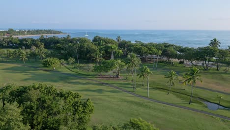 aerial orbit shot of golf club court beside playa dorada beach in puerto plata,dominican republic