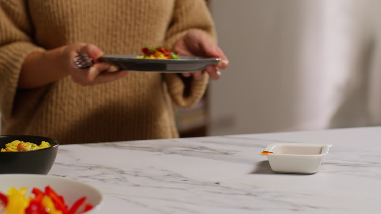 가정에서 부에서 건강한 채식주의자 또는 채식주의자의 식사를 준비하는 여성의 클로즈업 orzo 파스타와 구운 토마토 2