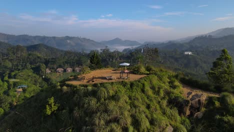 A-drone-shot-of-grassy-field-and-rolling-hills-with-cloudy-sky-background-in-day-time