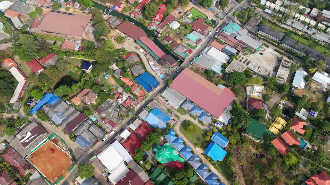 aerial drone footage of Koh Chang island, Kai Bae village with roads, shops , hotel accommodation and river