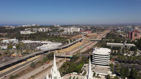 Highway-5-In-San-Diego-California-With-Revealing-Shot-Of-White-Mormon-Temple---drone-pullback