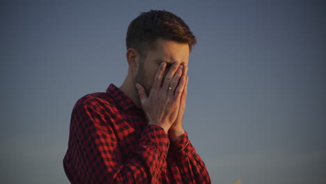 worried man against blue sky