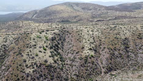 Drone-video-of-Arizona-mountains-and-desert-with-a-car-driving-in-the-distance