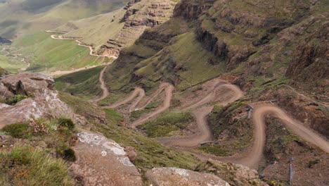 One-lone-truck-drives-down-rough,-dangerous-Sani-Pass-switchbacks