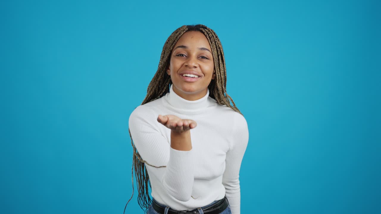 Young African American Woman Blowing Kisses and Waving