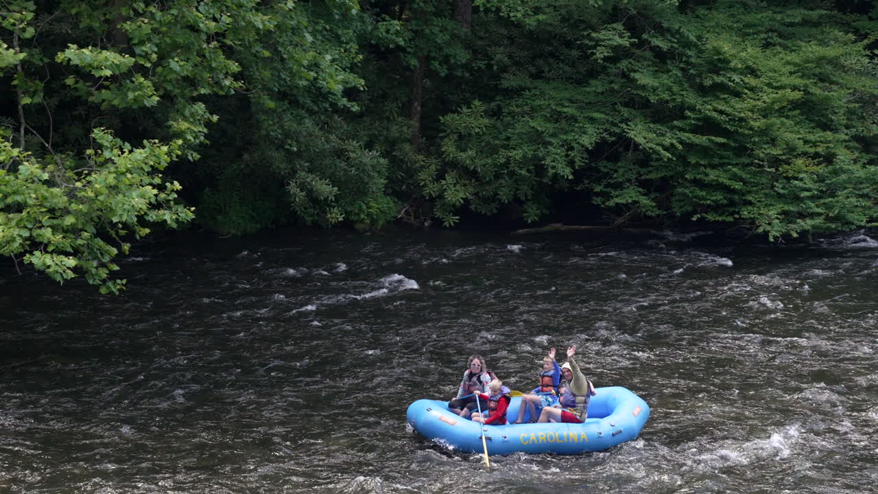 Young Family White Water Rafting In The River In The Smokey Mountains Of North Carolina Appalachia During Summer