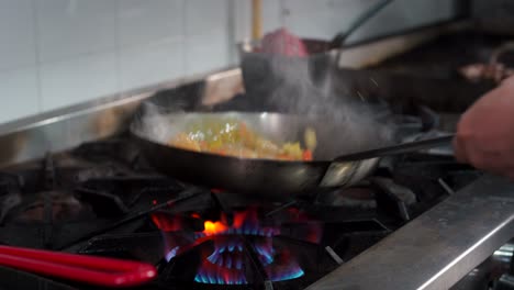 latin restaurant saute pan mexican bar cantina searing shrimps and vegetables for pasta recipe dish at kitchen by chef cooker