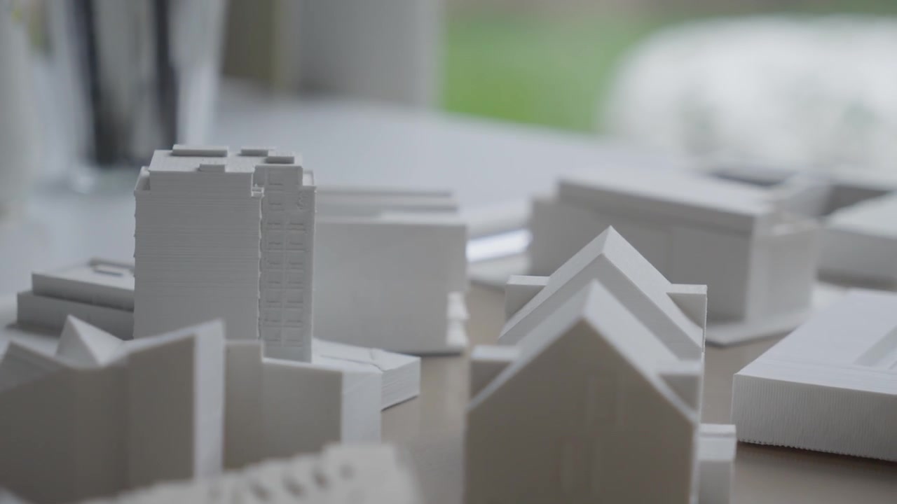 A detailed look at white scale models used for urban planning and residential design projects.