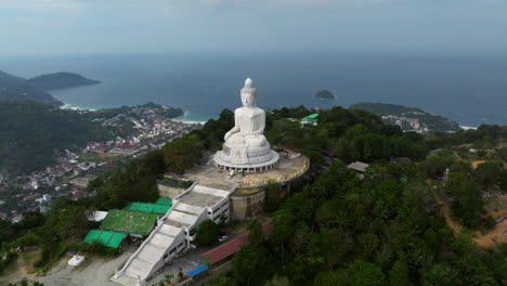 phuket big buddha in maravijaya attitude on nakkerd hill in phuket island, thailand. - aerial shot