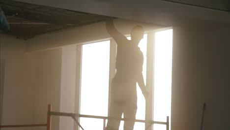 construction worker installing ceiling