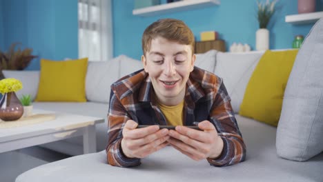 young man watching video with amazement.