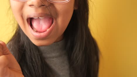 close-up of a girl with open mouth and dark hair