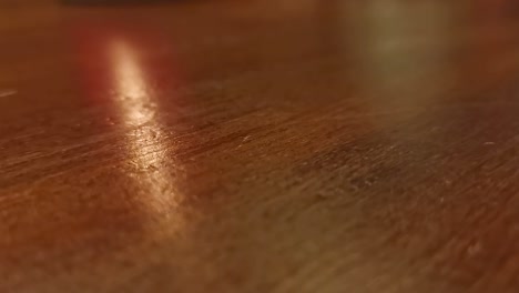 cup of dice being turned over onto an interior wooden table while playing a board game