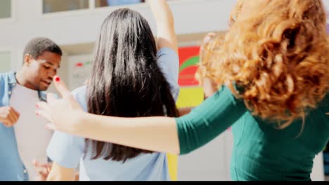 young diverse friends socializing and dancing outdoors in the city