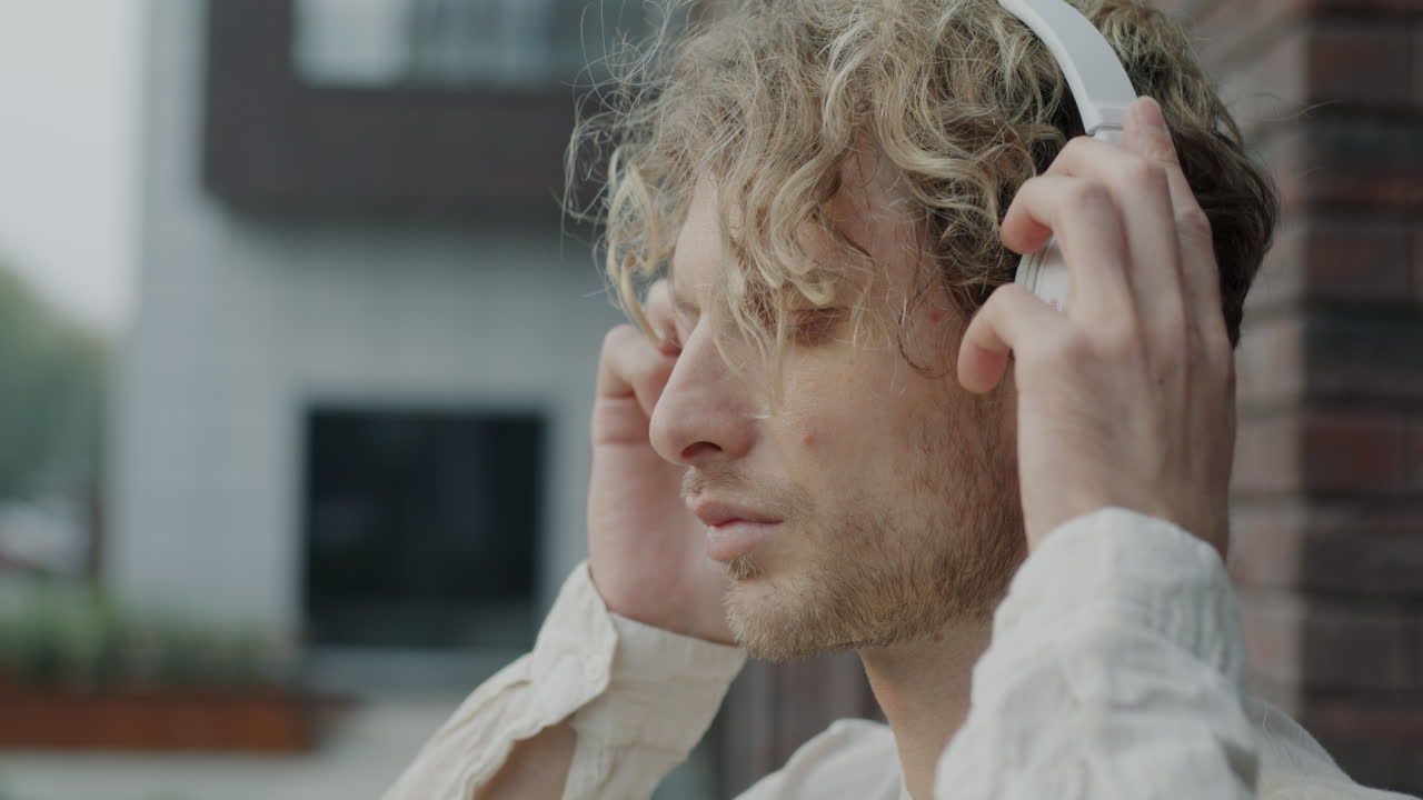 Man Listening to Music with Headphones Outdoors