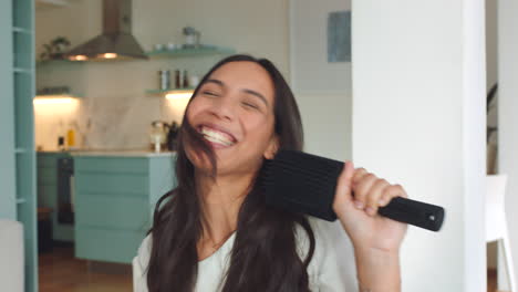 happy woman singing karaoke music with a hair