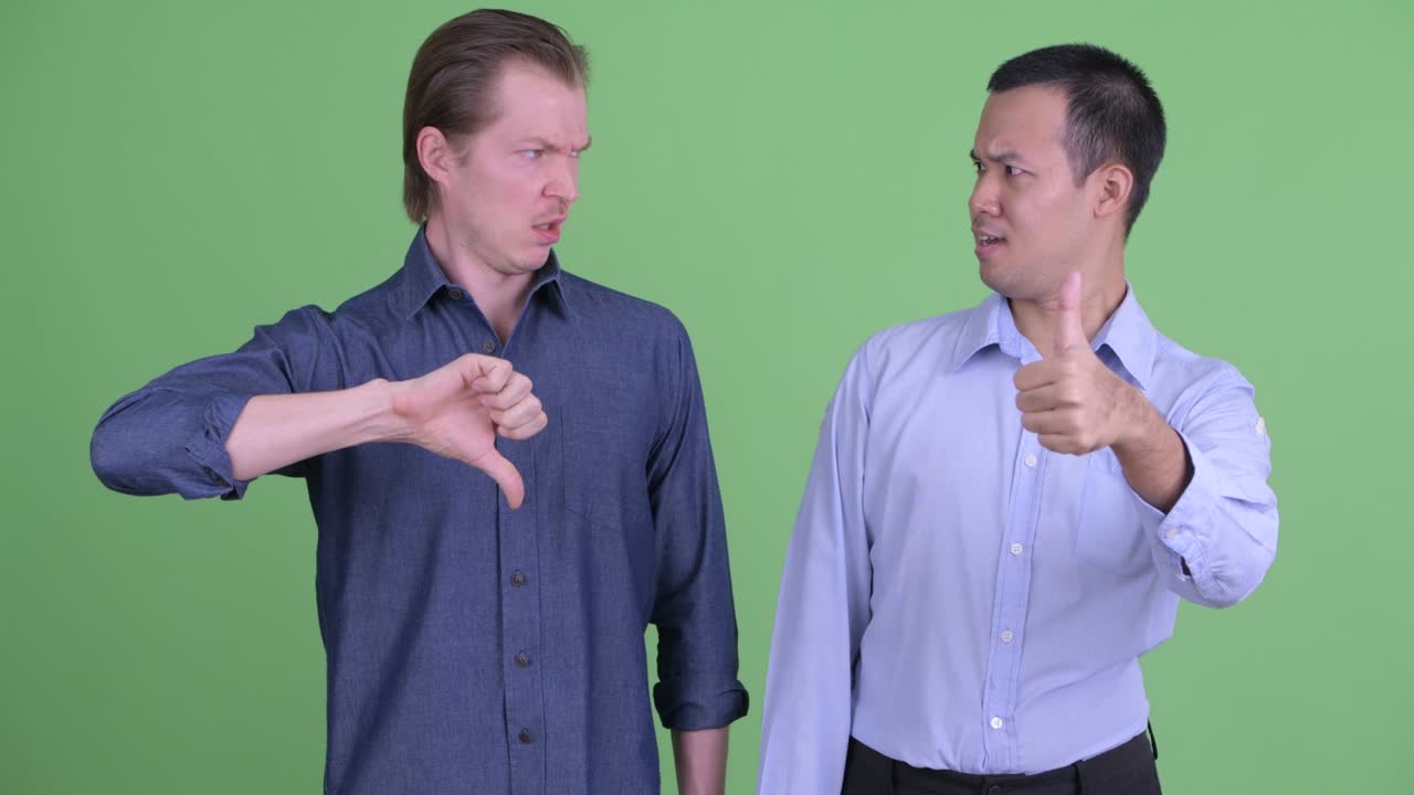 녹색 스튜디오 배경에 대해 서로 다른 의견을 가진 두 사업가