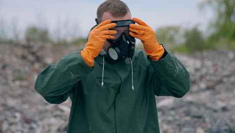 man wearing green chemical suit and gas mask. man in special radioactive uniform walking down.